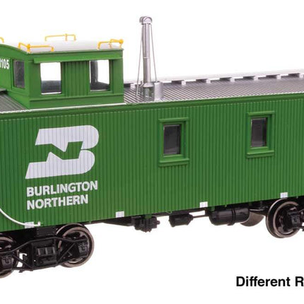 Burlington Northern HO scale 30' wood caboose model with offset cupola, showcasing green exterior and distinctive logo.