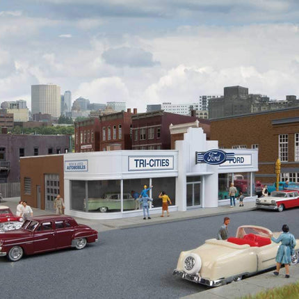 Walthers HO scale Vintage Ford Auto Dealer building kit with classic cars and retro architecture on city street.