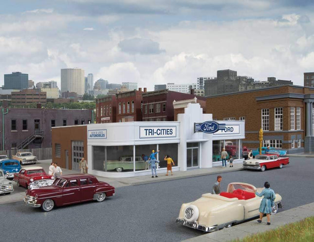 Walthers HO scale Vintage Ford Auto Dealer building kit with classic cars and retro architecture on city street.