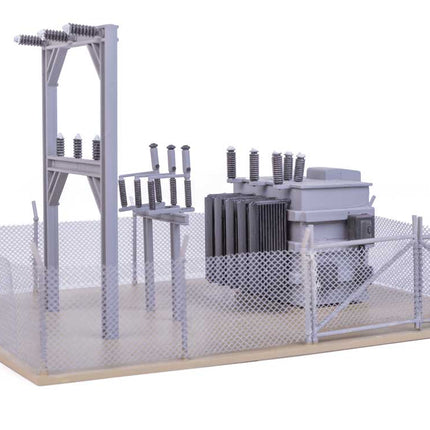Detailed HO scale transformer substation model with fencing and equipment for industrial layouts.