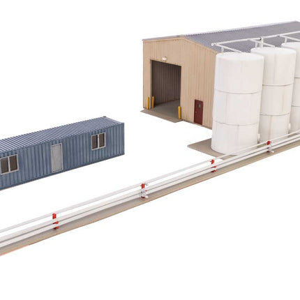 Walthers Cornerstone Corn Syrup Transfer Facility kit with tanks, storage building, and transfer pipes for HO scale model railroads.