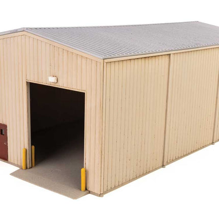 HO scale corn syrup transfer building kit with detailed exterior and open entryway.