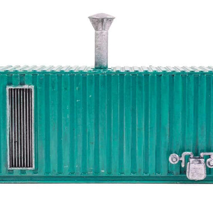 HO scale boiler house model kit in green, designed from a shipping container, featuring a chimney and door.