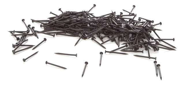 WalthersTrack blackened track nails pile, suitable for HO Scale track projects, approximately 300 pieces.