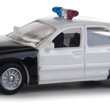 Walthers HO Ford Crown Victoria Police Interceptor model, black and white patrol car with light bar, 1:87 scale.