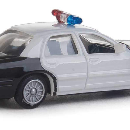 Walthers HO scale Ford Crown Victoria Police Interceptor model car, black and white, with lights on top.