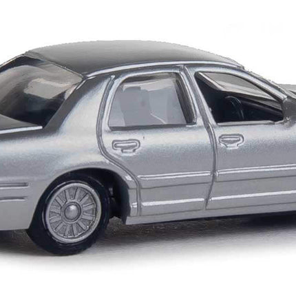 Walthers SceneMaster HO scale silver Ford Crown Victoria Police Interceptor model, unmarked and fully assembled for realistic scenes.