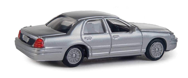 Walthers SceneMaster HO scale silver Ford Crown Victoria Police Interceptor model, unmarked and fully assembled for realistic scenes.