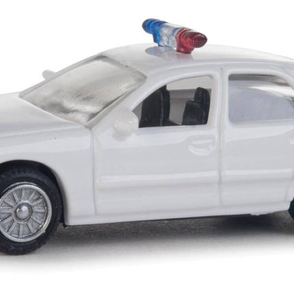 Walthers HO scale Ford Crown Victoria police interceptor model, all-white patrol car with rooftop lightbar.