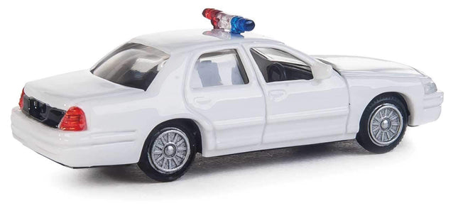 Walthers HO Ford Crown Victoria Police Interceptor model in white with rooftop lightbar, ideal for layouts and city scenes.