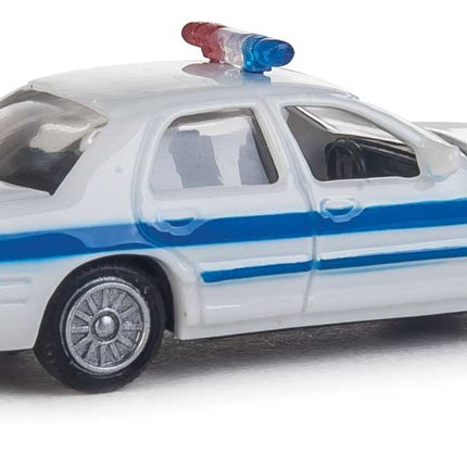 Walthers HO Ford Crown Victoria Police Interceptor model car, white with blue stripe, detailed design for layout display.