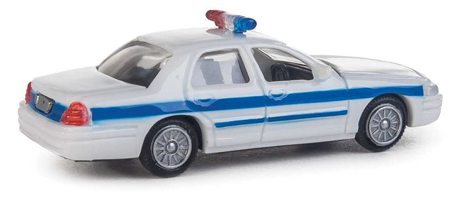 Walthers HO Ford Crown Victoria Police Interceptor model car, white with blue stripe, detailed design for layout display.