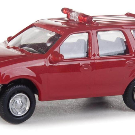 Walthers SceneMaster HO Scale Ford Expedition Fire Command Vehicle model, red with lightbar and detailed interior.