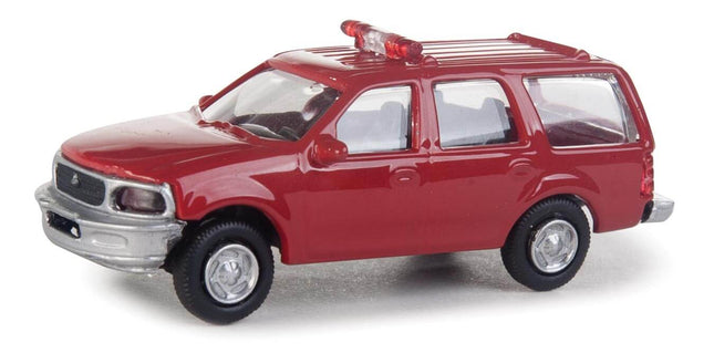Walthers SceneMaster HO Scale Ford Expedition Fire Command Vehicle model, red with lightbar and detailed interior.