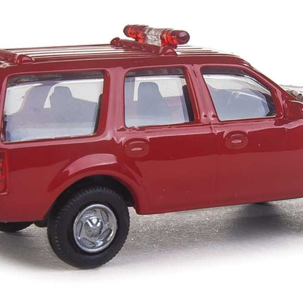 Walthers SceneMaster Ford Expedition SSV, red fire command vehicle, HO scale with lightbar and detailed interior.