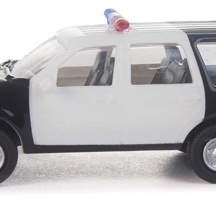 Walthers HO Ford Expedition Special Service Vehicle in black and white with police lights, ideal for city dioramas.