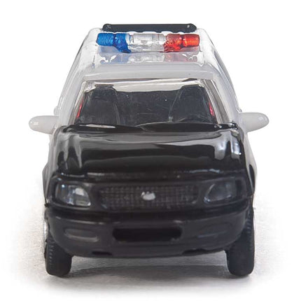 Walthers HO Ford Expedition Special Service Vehicle in black with white doors and light bar, ideal for model city scenes.