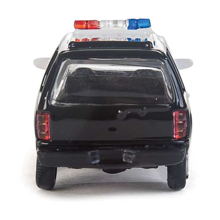 Walthers HO Ford Expedition black police vehicle model with lightbar, assembled for city scenes.