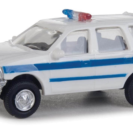 Walthers HO Ford Expedition SSV in white with blue stripe, detailed police SUV model for layouts.