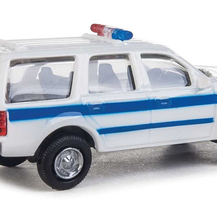 Walthers HO Scale Ford Expedition Special Service Vehicle in white with blue stripe and lightbar.