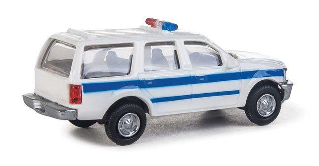 Walthers HO Scale Ford Expedition Special Service Vehicle in white with blue stripe and lightbar.