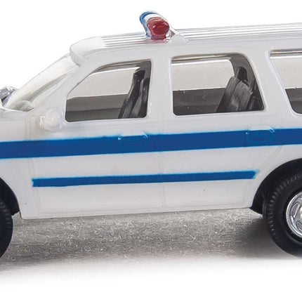Walthers HO Scale Ford Expedition Special Service Vehicle in white with blue stripe and lightbar, ideal for model layouts.