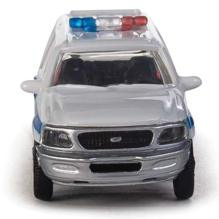 Walthers HO Ford Expedition Special Service Vehicle in white with blue stripe and lightbar, ideal for model layouts.