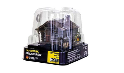 Woodland Scenics HO Scale Cozy Cabin in packaging, Landmark Structures, pre-lit and weathered model, ready for rural layouts.