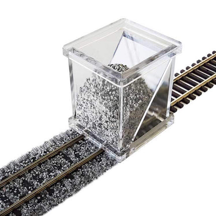 Bachmann HO Scale Ballast Spreader on track dispersing ballast for precise placement. Clear acrylic design for easy use.