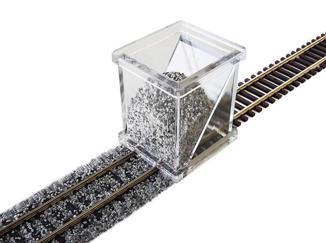 Bachmann HO Scale Ballast Spreader on track dispersing ballast for precise placement. Clear acrylic design for easy use.