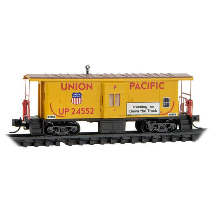 Micro Trains 130 00 291 | Steel Bay Window Caboose - Ready to Run - Union Pacific #24552 (Armour Yellow, red, Truckin' Safety Slogan) | N Scale - Squeaky's Trains