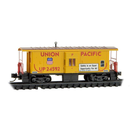 Micro Trains 130 00 292 | Steel Bay Window Caboose - Ready to Run - Union Pacific #24592 (Armour Yellow, red, Truckin' Safety Slogan) | N Scale - Squeaky's Trains