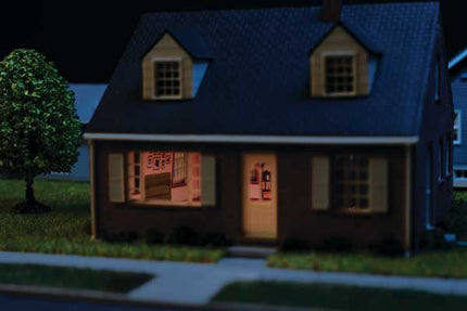 Walthers Cornerstone 933-4704 Brick Cape Cod House Spaces Interior Lighting HO Scale - assembled house at night with lit interior