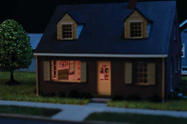Walthers Cornerstone 933-4704 Brick Cape Cod House Spaces Interior Lighting HO Scale - assembled house at night with lit interior
