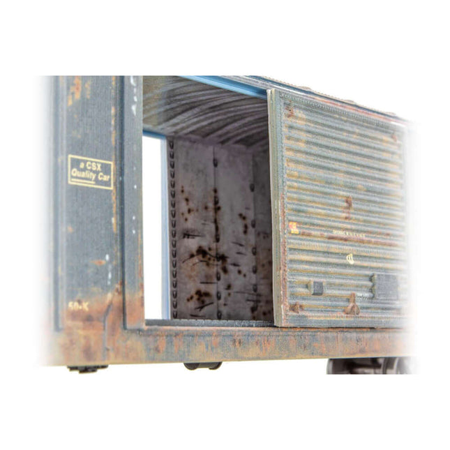 Detailed view of the weathered interior of a Micro-Trains CSX 50 foot boxcar kit, showcasing authentic grit and grime.