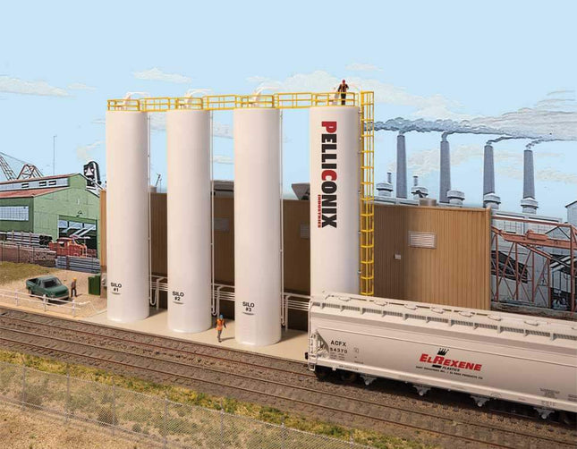 Walthers Cornerstone Plastic Pellet Plant Kit in HO Scale with silos and train, ideal for model railroad backdrops.
